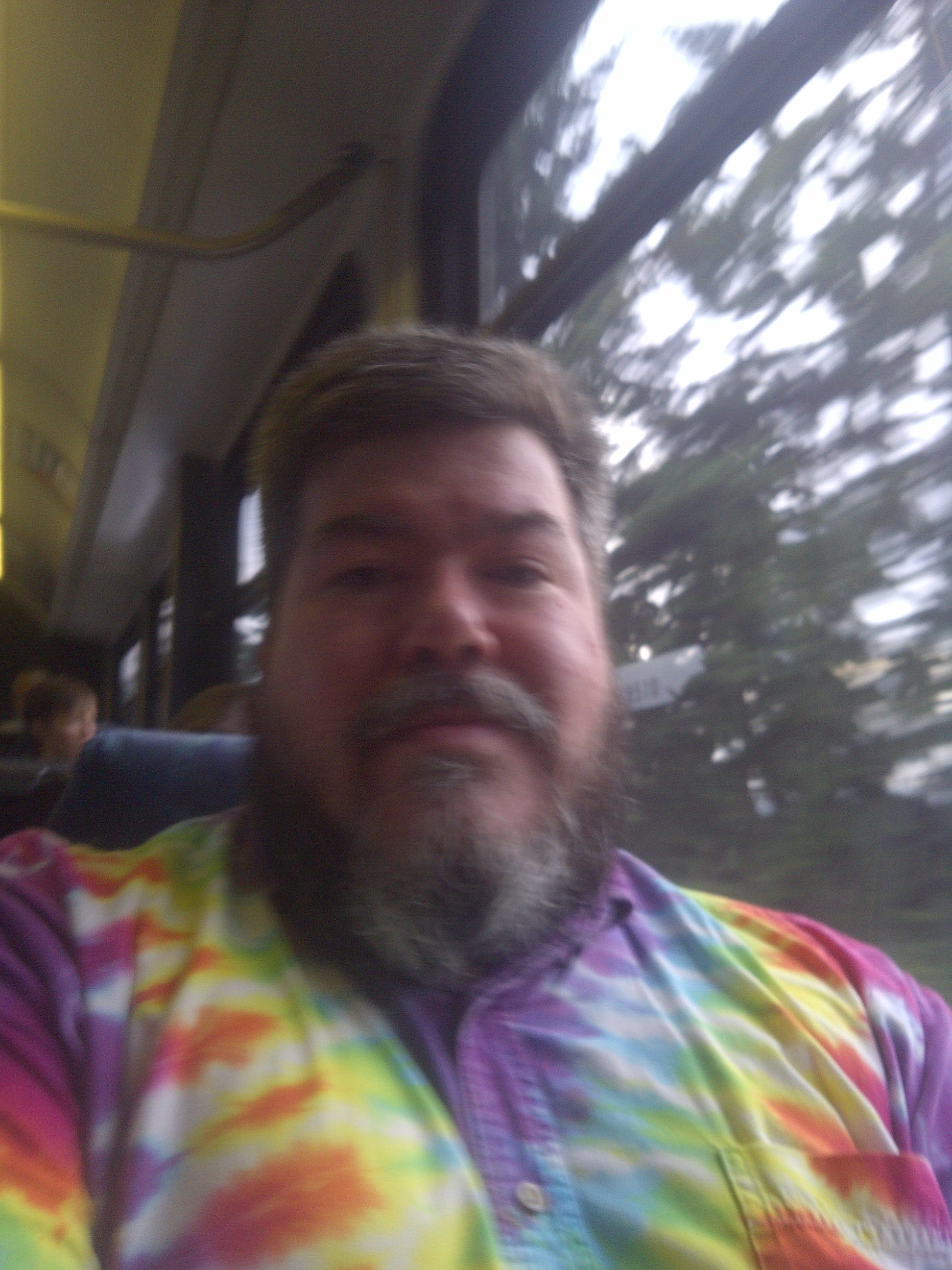 Selfie on a bus in a LOUD tie-dye dress shirt