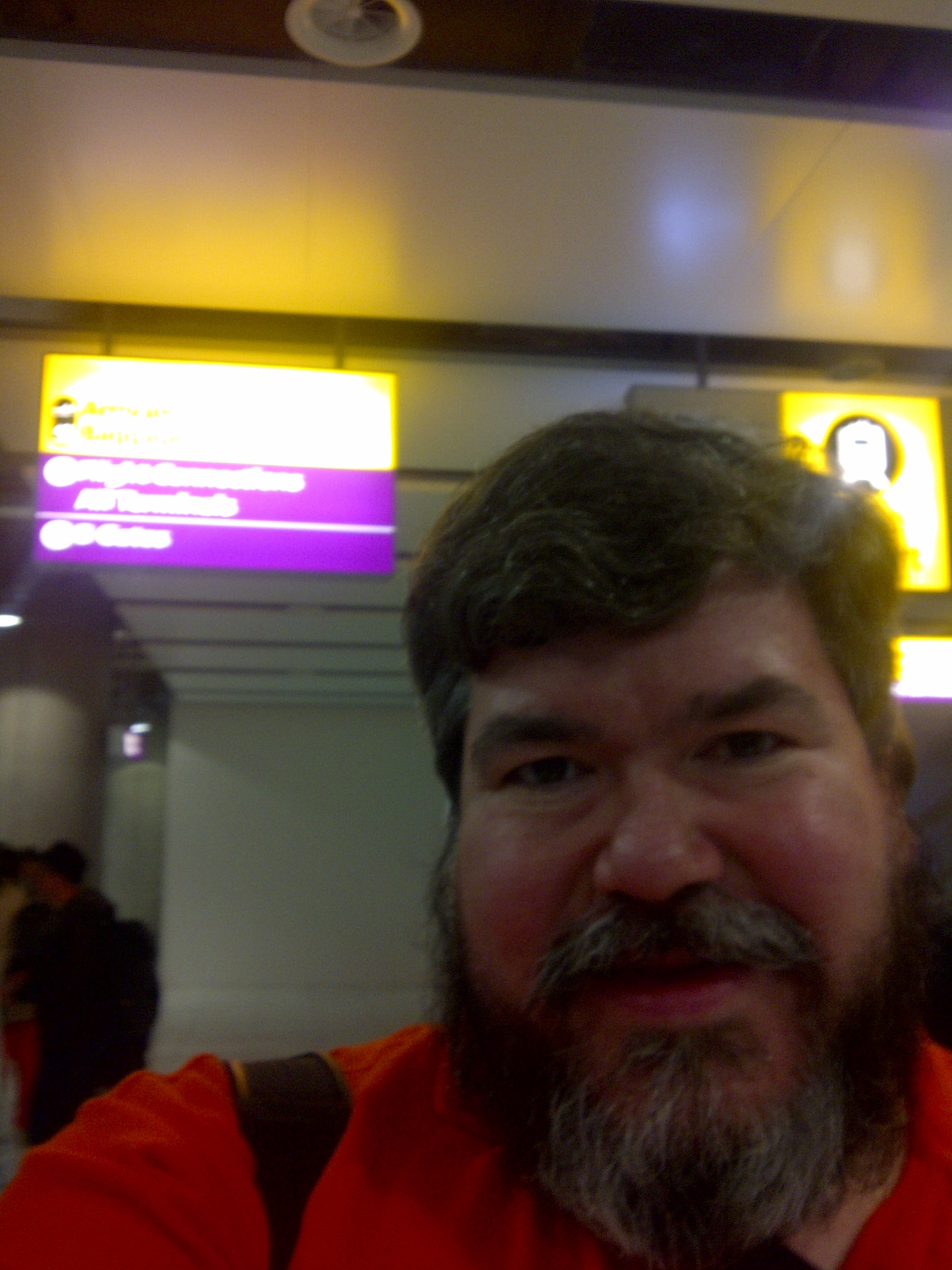 bigmacbear standing in front of illuminated sign at Heathrow Airport, London