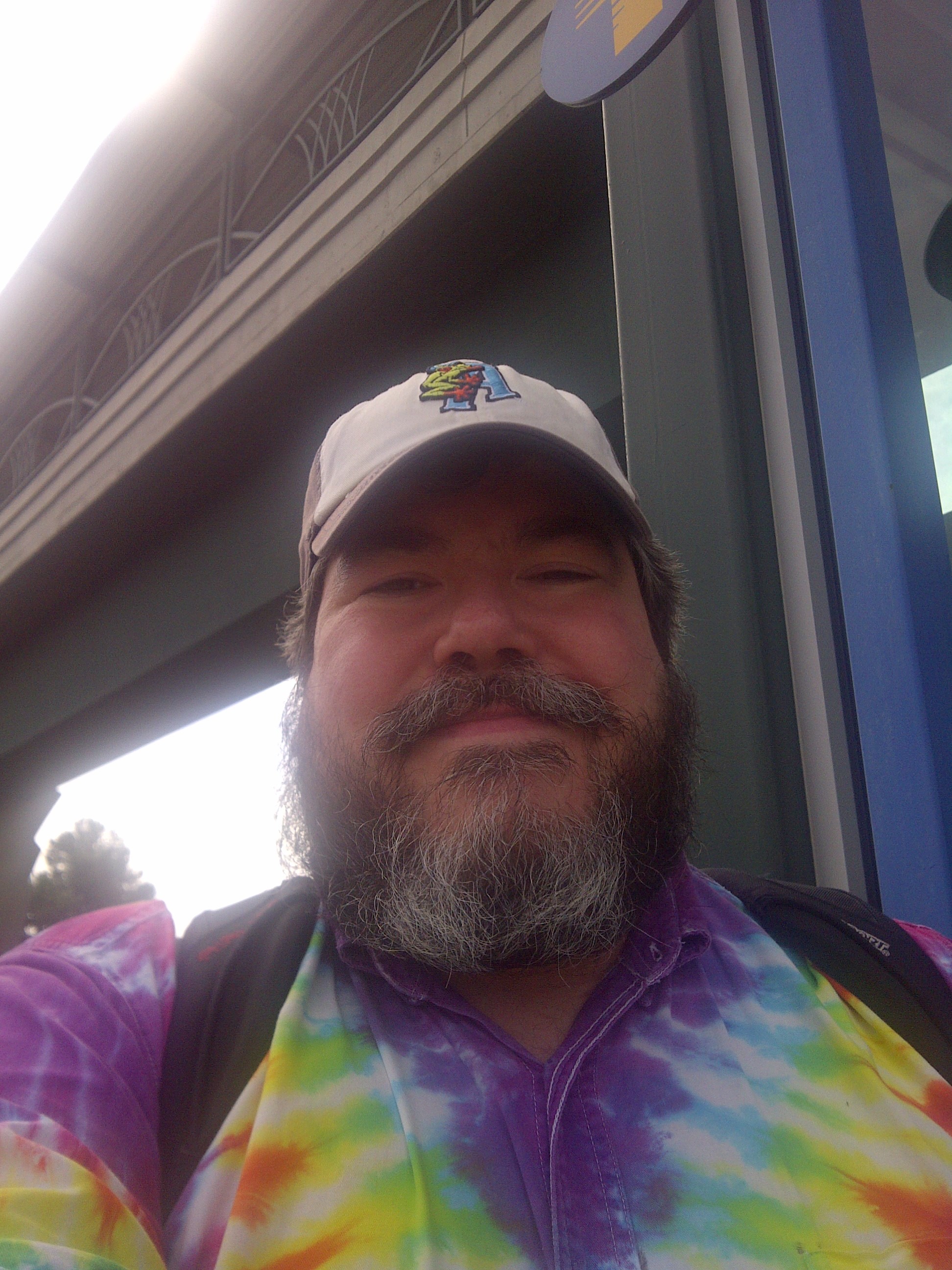 bigmacbear under the Canyon Park overpass, in a rainbow tie-dye dress shirt