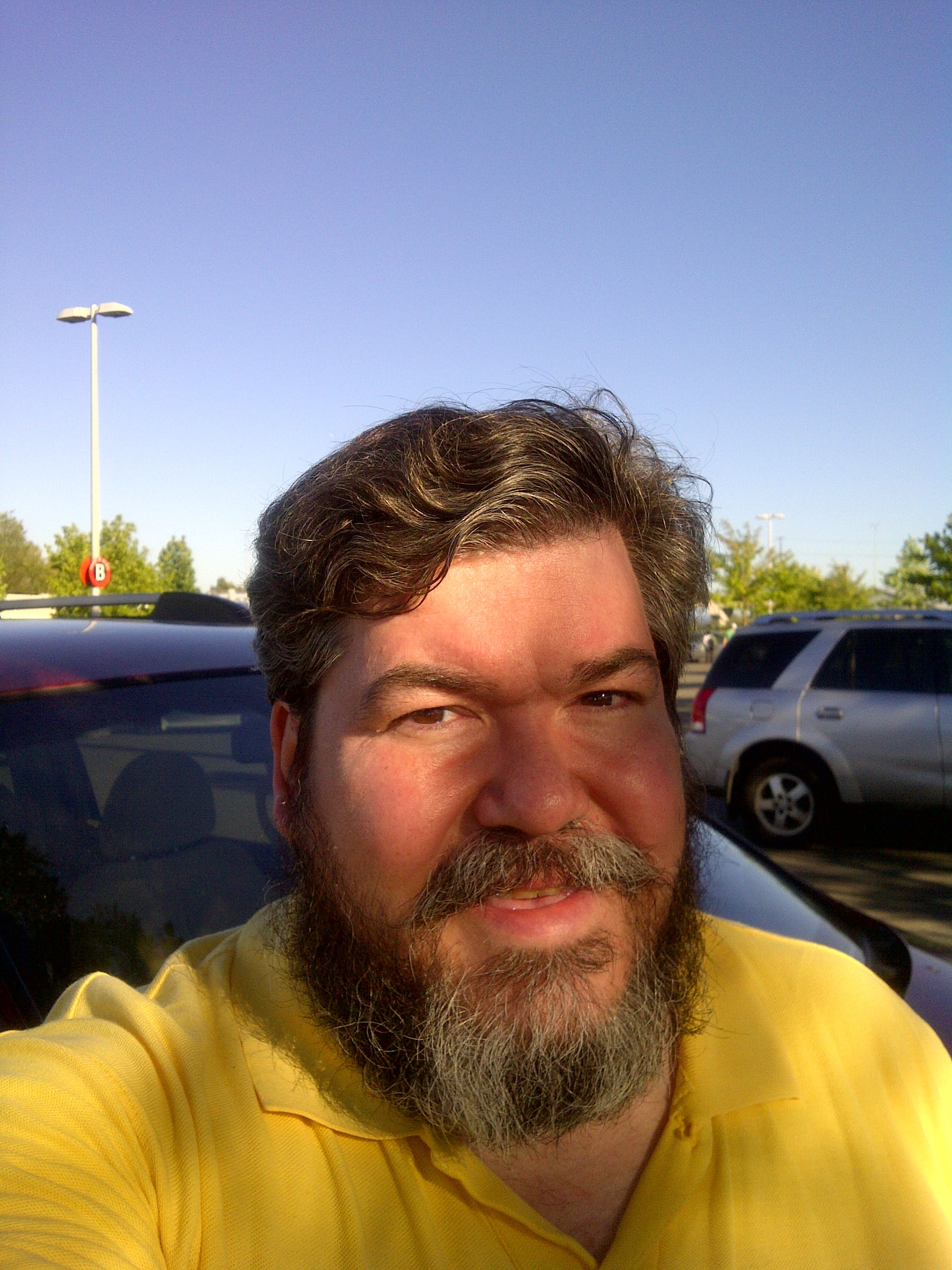 bigmacbear at Everett Station in front of a red Kia soccer-mom van