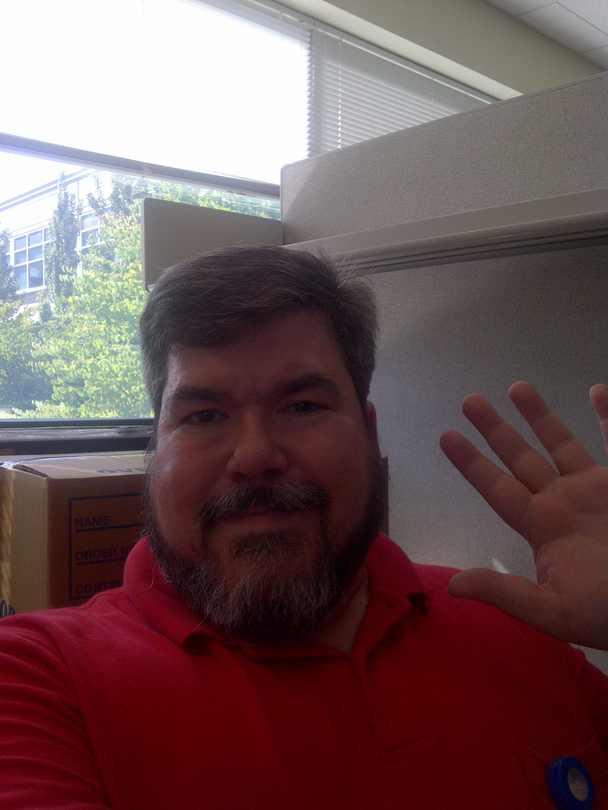 bigmacbear in his office, Bothell, WA, in a red polo shirt, waving goodbye 