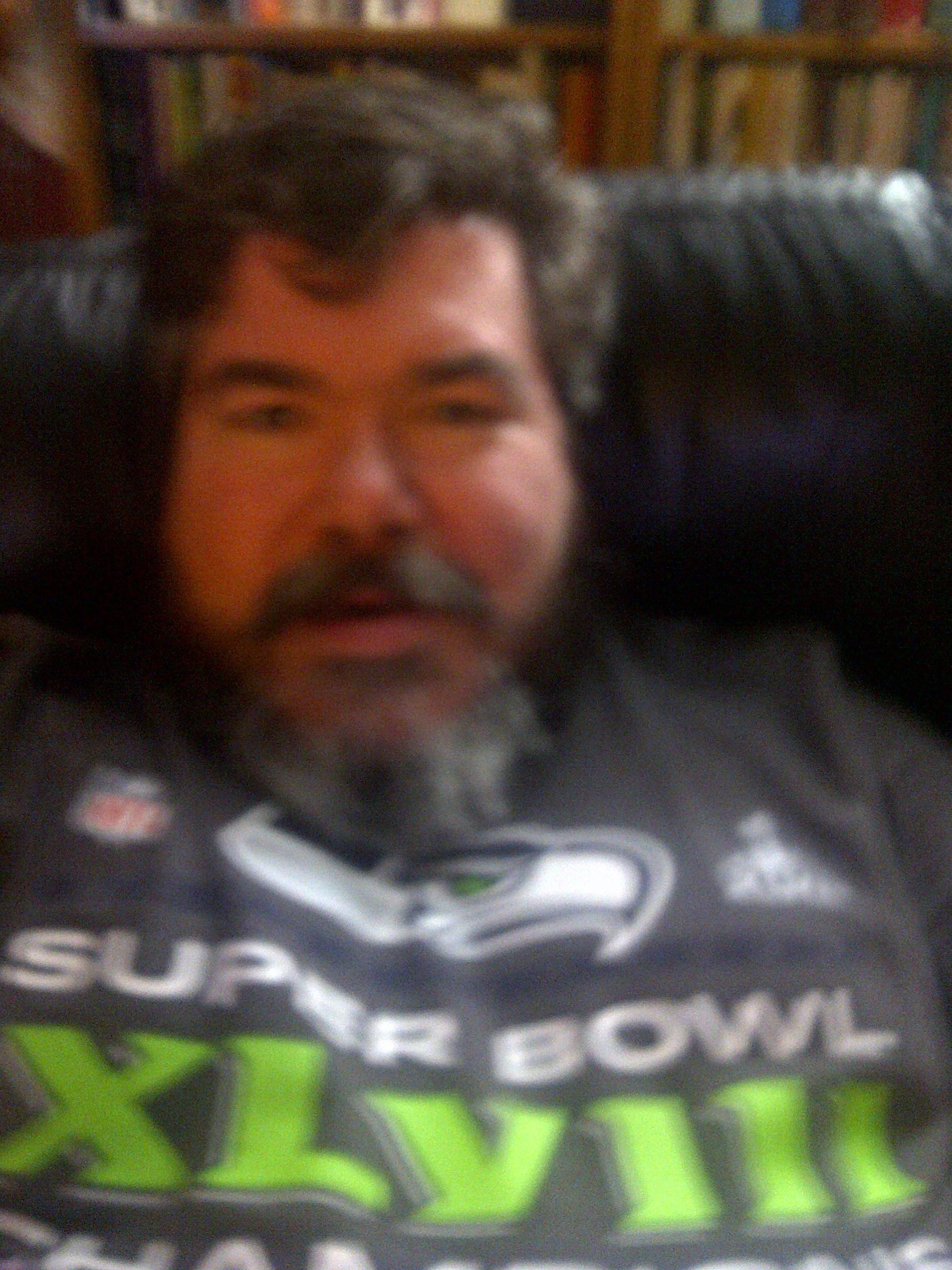 bigmacbear in a Seahawks Super Bowl XLVIII T-shirt lounging in a chair